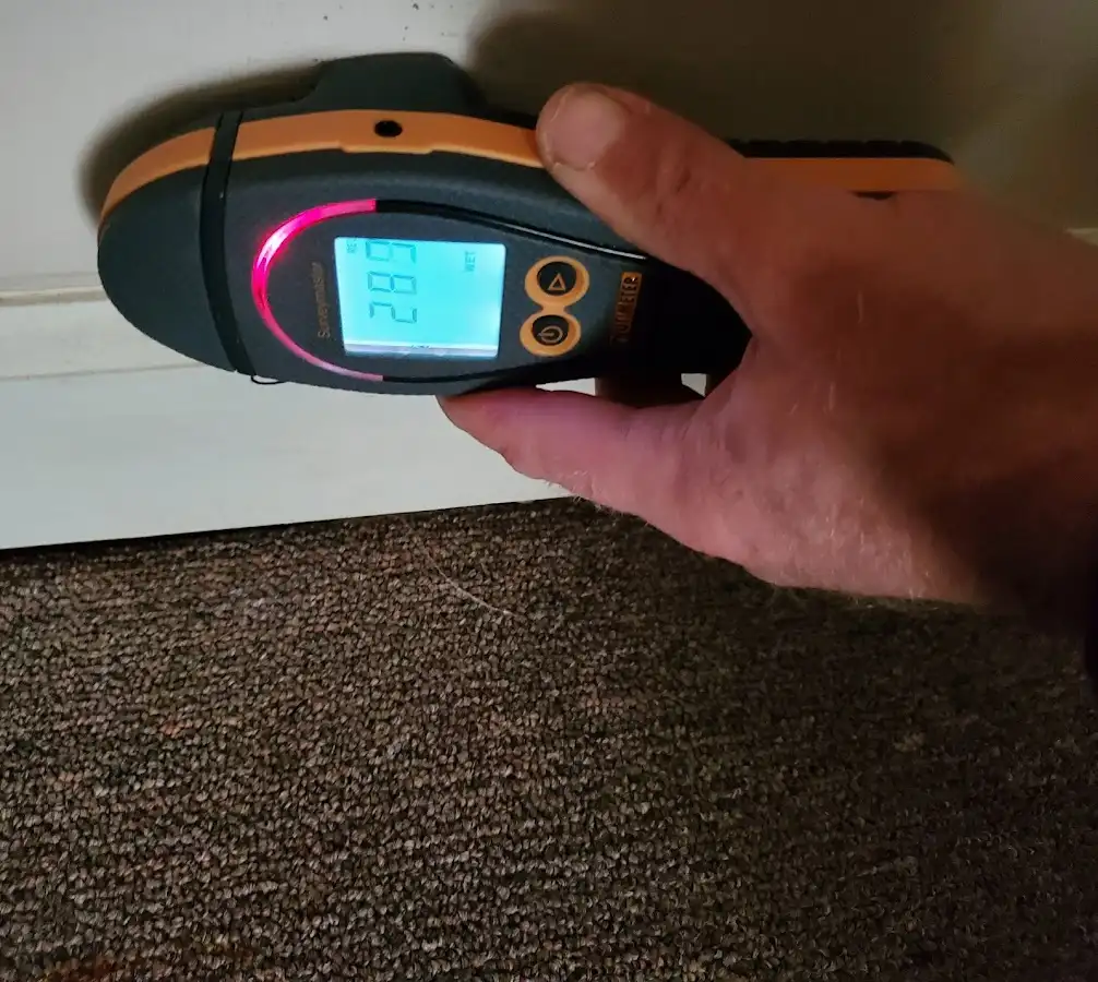 Moisture detection at baseboard during Storm Damage Restoration in Bardmoor